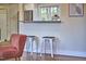 Eat-in kitchen bar area with seating, granite countertops and stainless refrigerator at 101 Newell St, Durham, NC 27705
