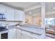 Open concept kitchen with granite counters flowing into a sunny dining area at 101 Newell St, Durham, NC 27705