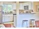 Modern kitchen featuring stainless steel appliances, white cabinetry, and a breakfast bar at 101 Newell St, Durham, NC 27705