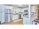 Spacious kitchen with stainless steel appliances, white cabinets, granite countertops, and hardwood floors at 101 Newell St, Durham, NC 27705