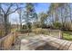 Wooden back deck with wood railing overlooks a wooded backyard with mature trees at 1012 Mountain Laurel Dr, Raleigh, NC 27603