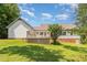 A spacious backyard features lush lawn, mature trees, and a deck, offering a serene outdoor experience at 1012 Mountain Laurel Dr, Raleigh, NC 27603