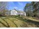 Spacious backyard featuring a wooden deck, lush lawn, and mature trees at 1012 Mountain Laurel Dr, Raleigh, NC 27603