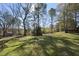 Expansive backyard with lush greenery and mature trees, creating a private oasis at 1012 Mountain Laurel Dr, Raleigh, NC 27603