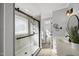 A modern bathroom features a walk-in shower with black hardware, white cabinets, and a sleek vanity at 1012 Mountain Laurel Dr, Raleigh, NC 27603