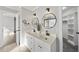 Bright bathroom with double sinks, framed mirrors, black fixtures, and walk-in shower access at 1012 Mountain Laurel Dr, Raleigh, NC 27603