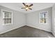 Spacious bedroom with neutral carpet, ceiling fan and natural light from two windows at 1012 Mountain Laurel Dr, Raleigh, NC 27603