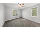 A cozy bedroom features two windows and a ceiling fan for comfort and light at 1012 Mountain Laurel Dr, Raleigh, NC 27603