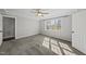 A calm bedroom features neutral walls and carpet, large window, and ceiling fan at 1012 Mountain Laurel Dr, Raleigh, NC 27603