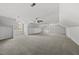 Spacious bonus room featuring neutral carpet, ceiling fans, and plenty of natural light at 1012 Mountain Laurel Dr, Raleigh, NC 27603
