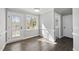 Bright dining area featuring hardwood floors, a window, and a door leading to the outdoors at 1012 Mountain Laurel Dr, Raleigh, NC 27603
