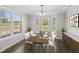 Dining room featuring a table set for dinner with large windows overlooking the yard at 1012 Mountain Laurel Dr, Raleigh, NC 27603