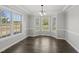 Dining room featuring large windows, hardwood floors, and elegant trim details at 1012 Mountain Laurel Dr, Raleigh, NC 27603