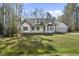 Charming home featuring a classic design, complemented by a well-manicured front lawn and natural surroundings at 1012 Mountain Laurel Dr, Raleigh, NC 27603