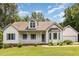 Charming one-story home with a front porch, manicured lawn, and well-maintained landscaping at 1012 Mountain Laurel Dr, Raleigh, NC 27603