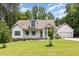 Charming one-story home featuring a well-manicured lawn, mature tree, and lovely landscaping at 1012 Mountain Laurel Dr, Raleigh, NC 27603