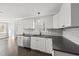 Kitchen featuring white cabinets, stainless steel appliances, and modern fixtures at 1012 Mountain Laurel Dr, Raleigh, NC 27603