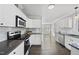 Modern kitchen featuring sleek appliances, elegant white cabinetry, and ample counter space, ideal for cooking and entertaining at 1012 Mountain Laurel Dr, Raleigh, NC 27603