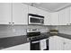 The kitchen features stainless steel appliances, modern countertops, and ample cabinet space for storage and organization at 1012 Mountain Laurel Dr, Raleigh, NC 27603