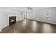 Spacious living room boasts a fireplace, hardwood floors, and ample natural light from the surrounding windows at 1012 Mountain Laurel Dr, Raleigh, NC 27603