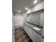 Bathroom features double sink granite vanity, white cabinets and vinyl flooring at 108 Faucette Dr, Selma, NC 27576