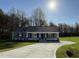 Charming one story home with a long concrete drive and meticulously landscaped front yard at 108 Faucette Dr, Selma, NC 27576