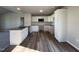 Bright kitchen boasts white cabinets, hardwood flooring and stainless steel appliances at 108 Faucette Dr, Selma, NC 27576