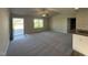 Spacious living room featuring neutral paint, modern fan, and plush carpet flooring at 108 Faucette Dr, Selma, NC 27576