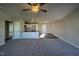 Open concept living room featuring a ceiling fan and hardwood leading into the kitchen at 108 Faucette Dr, Selma, NC 27576