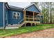 View of new construction home's back porch with wood decking, stairs, and backyard at 110 Purslane Dr, Franklinton, NC 27525
