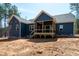 Newly built home with blue siding, a spacious backyard, and a covered wooden deck, perfect for outdoor gatherings at 110 Purslane Dr, Franklinton, NC 27525