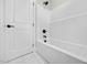 Bright bathroom featuring a tub with black fixtures and a white door at 110 Purslane Dr, Franklinton, NC 27525