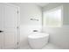Bathroom with a standalone tub, tile floors, and modern fixtures at 110 Purslane Dr, Franklinton, NC 27525