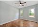 Sunny bedroom with hardwood floors, neutral walls, and two windows overlooking the yard at 110 Purslane Dr, Franklinton, NC 27525