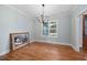Light and bright dining room with hardwood floors, modern chandelier, and large window at 110 Purslane Dr, Franklinton, NC 27525