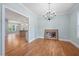 Open dining room with hardwood floors, blue walls, and chandelier at 110 Purslane Dr, Franklinton, NC 27525