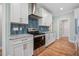 Kitchen featuring white cabinets, stainless steel appliances, and backsplash at 110 Purslane Dr, Franklinton, NC 27525