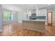 Open kitchen with hardwood floors, granite island, and pendant lighting at 110 Purslane Dr, Franklinton, NC 27525
