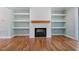 Bright living room featuring a fireplace, wood mantel, and built-in shelving at 110 Purslane Dr, Franklinton, NC 27525