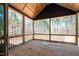 Outdoor screened-in porch with wood flooring, overlooking a peaceful wooded area, for relaxing and entertaining at 110 Purslane Dr, Franklinton, NC 27525