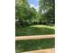 A view of a level, grassy backyard with a privacy fence at 1111 Lancaster St, Durham, NC 27701