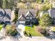 Aerial view of a beautiful home with a well-maintained lawn, landscaping, and a circular driveway at 113 Kings Castle Dr, Apex, NC 27502