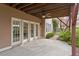 Covered patio area with glass doors and a ceiling fan provides an ideal spot for relaxing outdoors at 113 Kings Castle Dr, Apex, NC 27502
