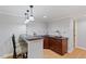 Finished bar area featuring custom cabinets, granite countertops, and pendant lighting at 113 Kings Castle Dr, Apex, NC 27502