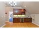 This entertainment area features custom wood cabinetry, granite countertops, and built-in wine cooler at 113 Kings Castle Dr, Apex, NC 27502