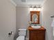Charming bathroom features wood vanity, sink, mirror and decorative light fixture at 113 Kings Castle Dr, Apex, NC 27502