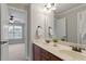 Bathroom featuring double sinks with a view into the bedroom at 113 Kings Castle Dr, Apex, NC 27502