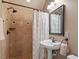 This bathroom features a shower and tub with tile, plus a stylish pedestal sink and vanity at 113 Kings Castle Dr, Apex, NC 27502