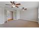 This bedroom features neutral paint, two ceiling fans, and hardwood flooring visible through the doorway at 113 Kings Castle Dr, Apex, NC 27502