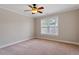 Cozy bedroom with neutral paint, soft carpet, ceiling fan, and plenty of natural light at 113 Kings Castle Dr, Apex, NC 27502